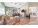 Comfortable living room with natural light, hardwood floors, and stylish decor at 10986 Se 171St Street Rd, Summerfield, FL 34491