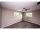 Bedroom features natural light from dual windows and wood-look floors at 110 River Beach Dr, Ormond Beach, FL 32176