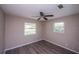 Bedroom with two windows and wood-look floors at 110 River Beach Dr, Ormond Beach, FL 32176