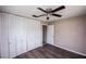 This cozy bedroom features a ceiling fan, wood floors, and ample closet space at 110 River Beach Dr, Ormond Beach, FL 32176