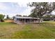 Inviting single-level home with brick details, carport, tidy landscaping, and cozy covered porch at 110 River Beach Dr, Ormond Beach, FL 32176