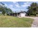 Charming single-story home with a brick facade, attached garage, and spacious front yard at 110 River Beach Dr, Ormond Beach, FL 32176