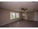 Open living room with modern flooring, a ceiling fan, and expansive windows for a bright and airy feel at 110 River Beach Dr, Ormond Beach, FL 32176