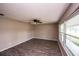 Bright living room features a ceiling fan, laminate floors, and large windows providing ample natural light at 110 River Beach Dr, Ormond Beach, FL 32176