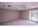 Bright living room with ceiling fan and glass doors to the backyard at 110 River Beach Dr, Ormond Beach, FL 32176
