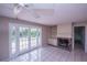 Cozy living area with a brick fireplace and French doors to the backyard at 110 River Beach Dr, Ormond Beach, FL 32176