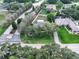 Aerial view of a home with a large yard and mature landscaping at 11036 Bronson Rd, Clermont, FL 34711