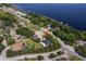 A real estate image captures an aerial view of a residence, set against the backdrop of a serene lake at 11036 Bronson Rd, Clermont, FL 34711