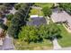 Aerial view of a home with a large fenced yard and mature landscaping at 11036 Bronson Rd, Clermont, FL 34711