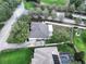 Aerial view of home with mature landscaping, fenced yard, and patio at 11036 Bronson Rd, Clermont, FL 34711