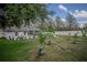 Expansive backyard with mature trees and a patio is perfect for outdoor entertaining at 11036 Bronson Rd, Clermont, FL 34711