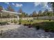 Expansive fenced backyard with brick patio and seating area at 11036 Bronson Rd, Clermont, FL 34711