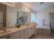 Bright bathroom featuring a double vanity, soaking tub, and glass enclosed shower at 11036 Bronson Rd, Clermont, FL 34711