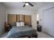 Bedroom featuring ceiling fan, wardrobe doors, and a neutral color palette for a relaxing atmosphere at 11036 Bronson Rd, Clermont, FL 34711