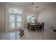 Bright dining area with an elegant table setting near French doors and a large window at 11036 Bronson Rd, Clermont, FL 34711