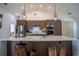 Spacious kitchen with island and stylish pendant lighting, modern cabinets, and bar seating at 11036 Bronson Rd, Clermont, FL 34711