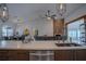 Open-concept kitchen with stainless steel appliances and an island leading into the living area at 11036 Bronson Rd, Clermont, FL 34711