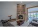 Cozy living room featuring a stone fireplace and a comfortable gray sofa at 11036 Bronson Rd, Clermont, FL 34711