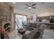 Living room with modern fireplace feature, a comfortable gray couch, and bright lighting at 11036 Bronson Rd, Clermont, FL 34711