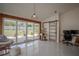Bright sunroom featuring a comfortable chair, large windows, and sliding barn door at 11036 Bronson Rd, Clermont, FL 34711