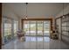 Relaxing sunroom with large windows, a comfortable chair, and access to the fenced yard at 11036 Bronson Rd, Clermont, FL 34711