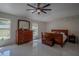 Bright bedroom with tile floors, ceiling fan, and a view to the backyard at 11036 Bronson Rd, Clermont, FL 34711