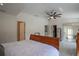 Bright bedroom with tile floors, ceiling fan, with a door to the walk-in closet at 11036 Bronson Rd, Clermont, FL 34711