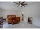 Bright bedroom featuring tile floors, a ceiling fan, and access to the bathroom at 11036 Bronson Rd, Clermont, FL 34711