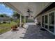 The covered brick patio has ceiling fans and is steps away from the beautiful, sprawling backyard at 11036 Bronson Rd, Clermont, FL 34711