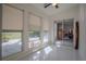 Bright sunroom featuring tile floors, large windows with shades and sliding doors at 11036 Bronson Rd, Clermont, FL 34711
