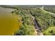 Overhead view of homes along a lake, featuring docks and lush vegetation enhancing the waterfront appeal at 1107 Northshore Dr, Eustis, FL 32726