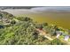 This aerial view captures a waterfront property with a serene lake and lush green trees at 1107 Northshore Dr, Eustis, FL 32726