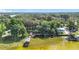 Wide aerial view of waterfront homes with private boat docks, and lush, mature trees at 1107 Northshore Dr, Eustis, FL 32726