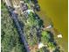 Aerial view showcasing waterfront property with private dock and lush green surroundings at 1107 Northshore Dr, Eustis, FL 32726
