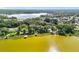 Aerial view showcasing waterfront homes with docks along a picturesque lake and tree line at 1107 Northshore Dr, Eustis, FL 32726