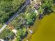 An aerial view of a lakefront neighborhood featuring houses with docks and mature trees at 1107 Northshore Dr, Eustis, FL 32726
