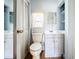 Bright bathroom with a classic toilet and a vanity by a window at 1107 Northshore Dr, Eustis, FL 32726