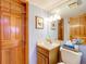 Bathroom boasting a wood vanity and decorative wood doors at 1107 Northshore Dr, Eustis, FL 32726