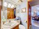 Bathroom with a wood vanity and views to the staircase at 1107 Northshore Dr, Eustis, FL 32726