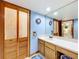 A beautiful blue bathroom boasts a spacious vanity with excellent lighting at 1107 Northshore Dr, Eustis, FL 32726