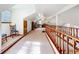 Spacious bonus room with a wooden railing, natural light, and neutral carpeting at 1107 Northshore Dr, Eustis, FL 32726