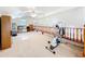 Bright bonus room featuring neutral carpet, a ceiling fan, and natural lighting at 1107 Northshore Dr, Eustis, FL 32726
