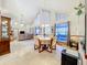 Bright dining area with vaulted ceilings, large windows, and stylish furnishings at 1107 Northshore Dr, Eustis, FL 32726