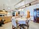 Open-concept kitchen and dining area with vaulted ceiling, perfect for entertaining at 1107 Northshore Dr, Eustis, FL 32726