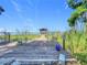 Scenic view of a wooden dock leading to a covered gazebo over a serene lake at 1107 Northshore Dr, Eustis, FL 32726