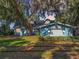 Charming home featuring neat landscaping and architectural detail at 1107 Northshore Dr, Eustis, FL 32726