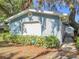 Quaint home exterior featuring neat landscaping and a security system at 1107 Northshore Dr, Eustis, FL 32726