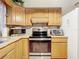 Traditional eat-in kitchen featuring oak cabinets and updated stainless steel appliances at 1107 Northshore Dr, Eustis, FL 32726