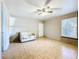 Bright living room featuring tile floors, a ceiling fan, and large windows at 1107 Northshore Dr, Eustis, FL 32726