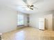 Functional living room showcasing tile floors, a ceiling fan, and a refrigerator at 1107 Northshore Dr, Eustis, FL 32726